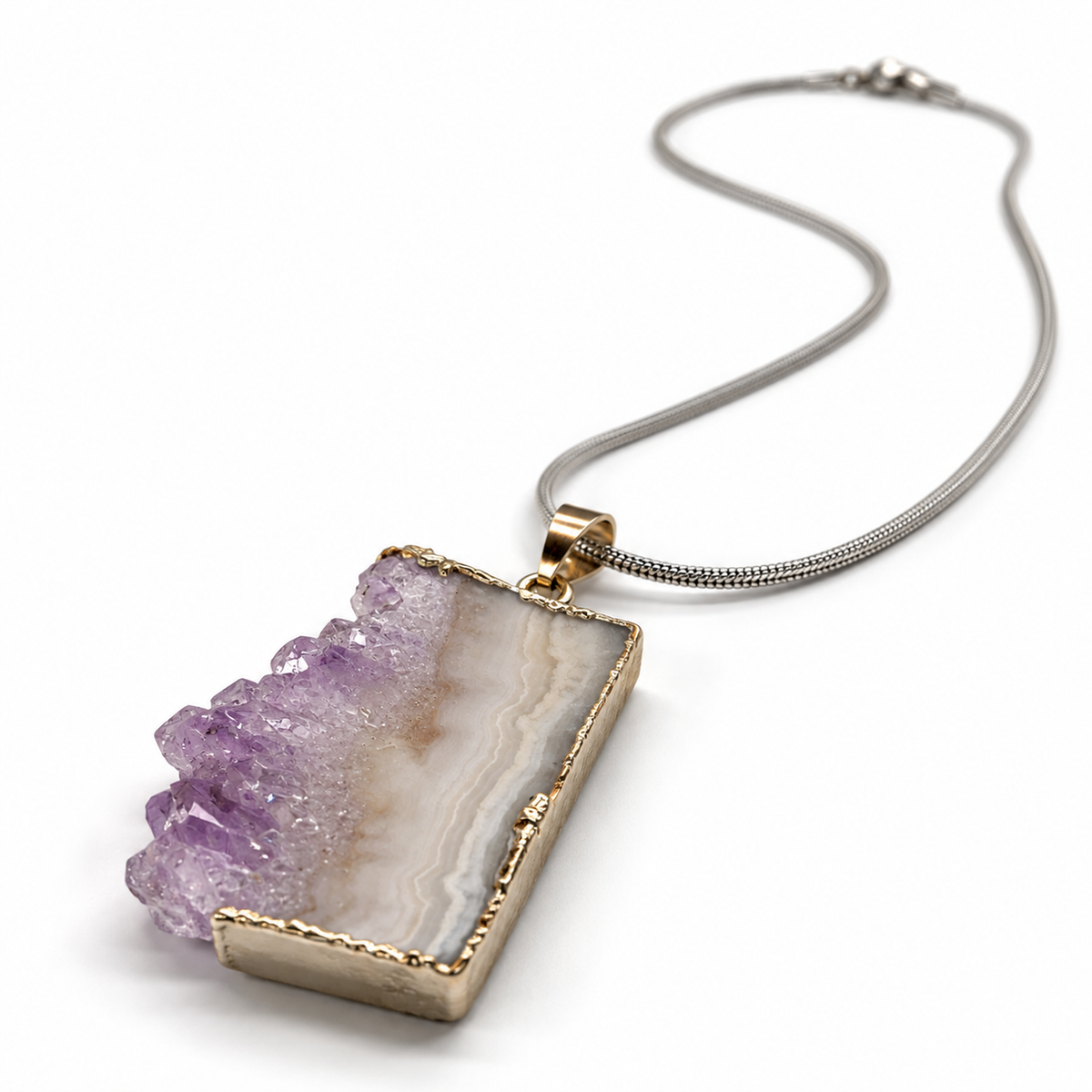 Low angled side view of amethyst druzy pendant necklace showing crystal depth, gold-tone edging, and silver-tone snake chain