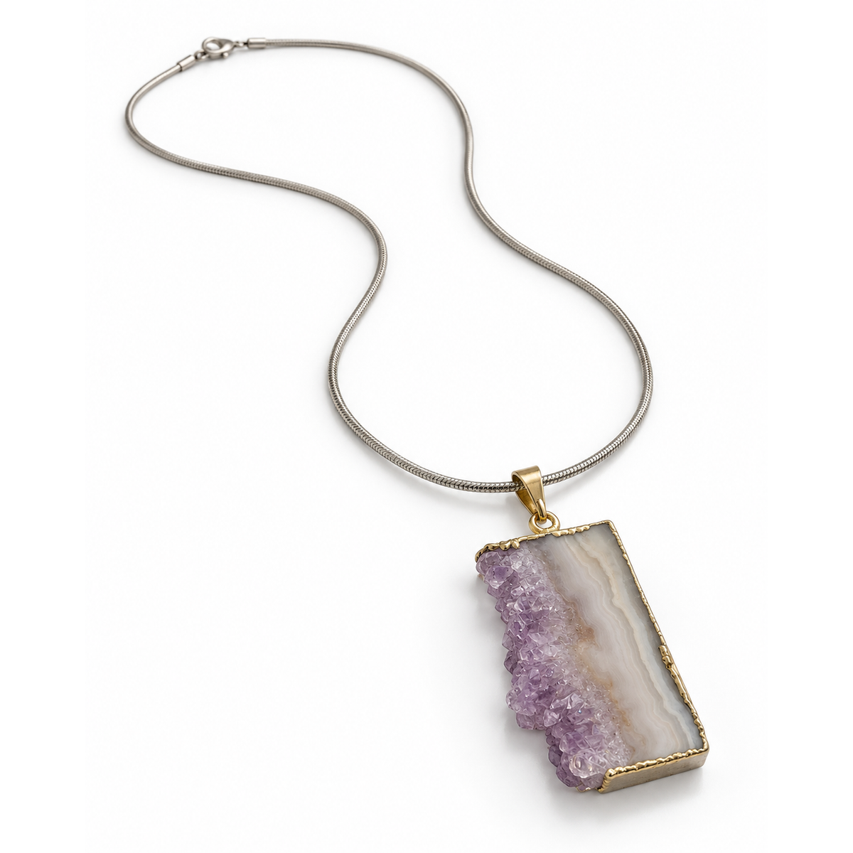 Amethyst druzy agate pendant necklace on silver-tone snake chain viewed at elevated three-quarter angle on white