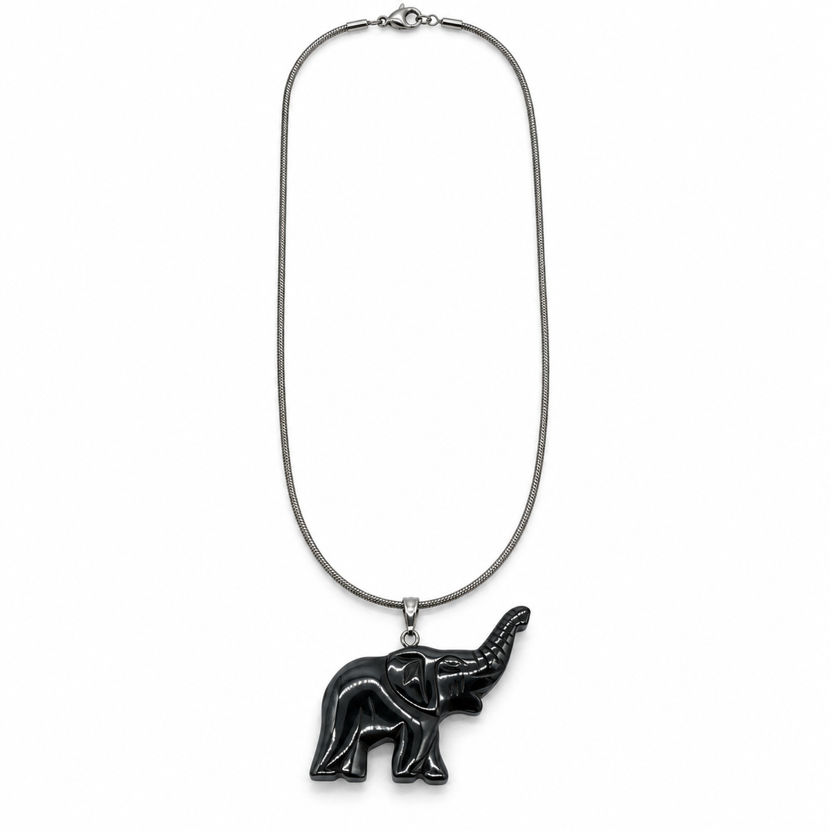 Full 24-inch silver-tone snake chain with carved glossy black elephant pendant and lobster clasp, overhead on white