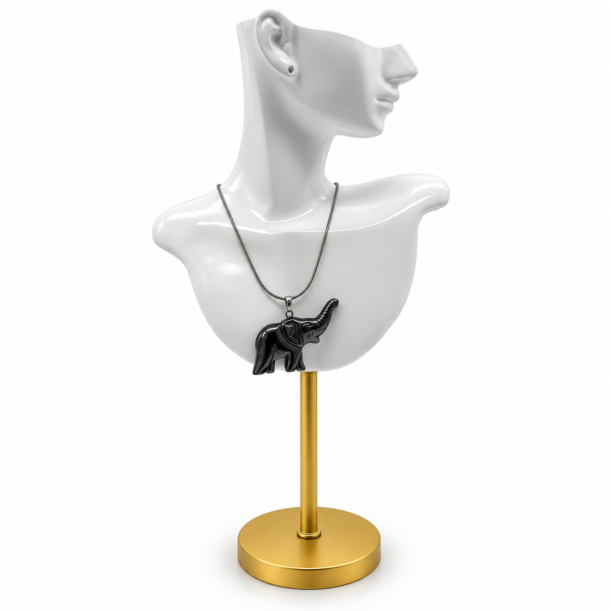 Glossy black elephant pendant necklace displayed on sculptural white ceramic jewelry bust with gold stand